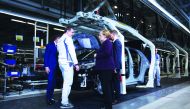 German Chancellor Angela Merkel talks with an employee as she visits VW's car factory in Zwickau, eastern Germany, on November 4, 2019 on the occasion of the start of the production of the new Volkswagen electric car, the ID.3 model. AFP / Ronny Hartmann