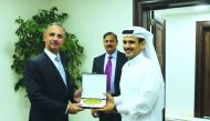 H E Saad Sherida Al Kaabi (right), Minister of  State for Energy Affairs, giving a memento to Omar Ayub Khan.