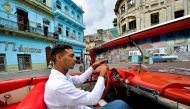 Cuban Yosbel Sosa, 33, drives his Chevrolet Impala '59 through the streets of Havana, on August 20, 2019, in search of tourists.  AFP / Yamil Lage 