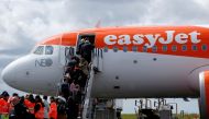 Passengers board an easyJet plane at the Nantes-Atlantique airport in Bouguenais near Nantes, France, April 4, 2019. Reuters/Stephane Mahe