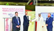 Mahday Saad Al Hebabi (second right) and Gonzalo Martin shaking hands in front of digital fitting room. 