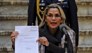 Bolivian interim President Jeanine Anez shows a document as she presents a bill on the Transition Electoral Regime for the 2020 general elections at Quemado presidential palace in La Paz on November 20, 2019. AFP / Jorge Bernal 