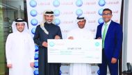 D Anand (right), QIB’s Personal Banking Group General Manager, and other QIB officials presenting cheque to the winner.