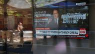 A large television in a bank shows CNN audio only broadcast of White House Press Secretary Sean Spicer's briefing in Boston, June 26, 2017. Reuters / Brian Snyder