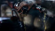 A man checks the heat of a pipe pouring with fuel inside a workshop in Douma neighbourhood of Damascus, Syria, April 1, 2017. Reuters / Bassam Khabieh