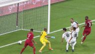 Qatar’s defender Abdelkarim Hassan (right) scoring a goal against Yemen during the 24th Arabian Gulf Cup Group A match at the Khalifa International Stadium in Doha, yesterday. Picture: Mohamed Farag