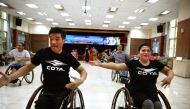 This photo taken on November 9, 2019 shows wheelchair dancers Ivy Huang (R) and Vincent Kuo (front L) with members of the Taiwan Wheelchair Dance Sport Association training for a performance at the Community Centre in New Taipei City. AFP / Hsu Tsun-hsu 