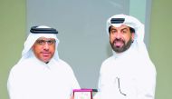 Rashid Al Mansoori (right), CEO of Qatar Stock Exchange,  presenting a memento to Dr. Hashem Al Sayyid during the event.
