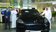The officials of Porsche Centre Doha, Salman Jassem Al Darwish (right), Chairman and CEO; and Ahed Dawood (second left), Brand Manager, during the launch of Cayenne Coupé at the Porsche Centre Doha, The Pearl-Qatar, in Doha yesterday. Pic: Salim Matramkot