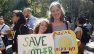 Aaron Thomases, 9, and his mother Teresa Elguera at the climate strike outside City Hall in New York City on September 27, 2019. Thomson Reuters Foundation / Rachel Savage