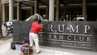 A worker removes the Trump name from the Trump Ocean Club International Hotel and Tower in Panama City, March 5, 2018. Reuters / Carlos Lemos