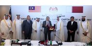 The visiting Malaysian Prime Minister H E Dr Mahathir Mohamad (fourth right) receiving a memento from the Chairman of Qatar Chamber, Sheikh Khalifa bin Jassim Al Thani, after the roundtable meeting with Qatari business leaders held at the St Regis Hotel i