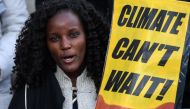A demonstrator holds a placard during a protest on climate emergency, called by environmental groups including Extinction Rebellion and Fridays For Future, outside the UN Climate Change Conference COP25 at the 'IFEMA - Feria de Madrid' exhibition centre, 