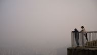 Image used for representation. Hikers stand at a viewpoint overlooking the city skyline shrouded in smog during heavily polluted weather conditions in Seoul on December 10, 2019.  / AFP / Ed JONES 