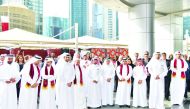 QFC officials and staff gather at the QFC Tower premises to celebrate Qatar National Day, yesterday.