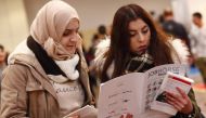 Two women visit the second job fair for migrants and refugees in Berlin, Germany, January 25, 2017. Reuters/Fabrizio Bensch 