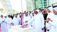 Sheikh Fahd bin Mohammed bin Jabr Al Thani, Chairman of the Board of Directors of Doha Bank, cutting a cake to mark opening of the celebrations.