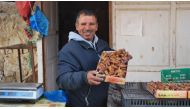 Lazhar Ghiloufi, a date seller in Kebili, south Tunisia, holds up a box of good quality deglet nour dates, December 2, 2019. Thomson Reuters Foundation/ Layli Foroudi