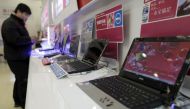 A customer looks at laptops at a Dell outlet in Beijing December 13, 2010. Reuters/Christina Hu
