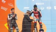 Mashel Al Naimi, receiving the winner's trophy from Abdulrahman Al Mannai, Qatar Motor and Motorcycle Federation (QMMF) President, during the Second Round of the Qatar Superstock 600 at Losail International Circuit this weekend. 