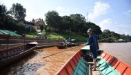 Niwat Roikaew, conservationist and head of the Rak Chiang Khong group, on a boat in the Chiang Khong district in the northern Thai province of Chiang Rai on September 20, 2019.  AFP / Lillian Suwanrumpha