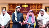 Qatar International Court CEO Faisal Al Sahouti (second left), presenting a memento to the head of  Kuwait delegation.