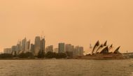 The haze from bushfires obscures the sun setting above the Sydney Opera House in Sydney, Australia, December 6, 2019. Reuters / John Mair