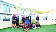 Abeer Marwan Al Kalla, Head of Corporate Communications and CSR; and ECGC golf professionals with local school students.