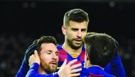 Barcelona's Argentine forward Lionel Messi (L) is congratulated by Barcelona's Spanish midfielder Riqui Puig after scoring the opening goal during the Spanish league football match between FC Barcelona and Granada FC at the Camp Nou stadium in Barcelona o