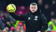 Manchester United's Norwegian manager Ole Gunnar Solskjaer throws the ball back in from the touchline during the English Premier League football match between Liverpool and Manchester United at Anfield stadium in Liverpool, north west England on January 1