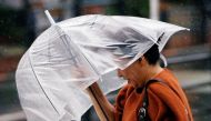 A passerby, using an umbrella, struggles against a heavy rain and wind in Tokyo, Japan, July 28, 2018. Reuters / Issei Kato
