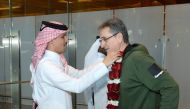 Qatar's victorious coach Valero Rivera greeted upon arrival at Hamad International Airport by Jassim bin Rashid Al Buenain, Secretary General of the Qatar Olympic Committee.