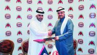 H E Ali bin Saud Al Thani, President of Al Rayyan Sports Club, and Moutaz Al Khayyat, Chairman of Baladna Food Industries, exchanging documents after a sponsorship-signing ceremony yesterday. 

