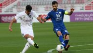 Al Sadd SC's Algerian striker Baghdad Bounedjah shoots to score while Al Kharaitiyat skipper Pejman Mohammadreza tries to spoil his effort during their Amir Cup Round of 16 match played at the Abdullah Bin Khalifa Stadium in Doha, yesterday. Pictures: Hus