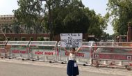 Youth climate activist, Licypriya Kangujam, holds up a poster to demand a law on climate change outside the federal parliament in New Delhi, India on February 2, 2019. The Child Movement handout