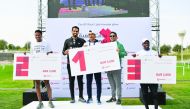 Vodafone Qatar’s brand ambassador, Mohammed Saadon Al Kuwari (second left), hands prizes to Qatar Foundation’s Obstacle winners, which was held as part of the National Sport Day celebrations.