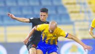 Players of Al Gharafa and Umm Salal vie for ball possession in this file picture.