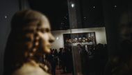 Visitors look at a version of 'The Last Supper' during the night and free opening of the 'Leonardo da Vinci' exhibition at The Louvre Museum on February 21, 2020, in Paris. AFP / LUCAS BARIOULET