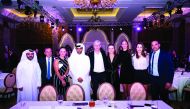 The players taking part in the Qatar Total Open pose for a picture with Qatar Tennis Federation President Nasser bin Ghanim Al Khelaifi, former Arsenal Manager Arsene Wenger and Tournament Director Karim Alami during the gala dinner in Doha on Sunday.