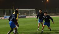 Al Gharafa's players during a training session ahead of their game against Al Wakrah. INSET: Coach Slavisa Jokanovic supervising a training session. 