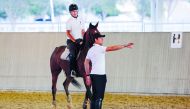 Belgian rider Nicola Philippaerts (right) offers tips to a young rider during the Internations Camp at Al Shaqab, on Tuesday.