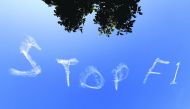 The words 'Stop F1' are seen over the Sydney sky yesterday.  Three Formula One team staff members have been isolated at the Australian Grand Prix while tests are conducted for the new coronavirus, officials said, casting a shadow over the opening race of 