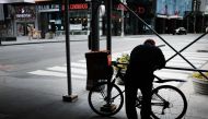  A delivery man pauses in an empty Times Square as much of the city is void of cars and pedestrians over fears of spreading the coronavirus on March 22, 2020 in New York City. Spencer Platt/Getty Images/AFP