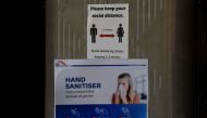 A sign reminding people of social distancing hangs inside a food court where restaurants are closed in Sydney on March 25, 2020, due to restrictions to stop the spread of the worldwide COVID-19 coronavirus outbreak. / AFP / Saeed KHAN