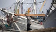A labourer unloads timber from Kalimantan province at Sunda Kelapa port in Jakarta, September 8, 2014. Reuters/Darren Whiteside 