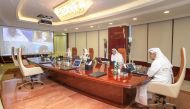 Turki bin Mohammed Al Khater (right), UDC Chairman, and other senior officials of the Company holding a meeting through the electronics communications, while maintaining the social distancing due to the COVID-19 pandemic, at the UDC headquarters in Doha, 