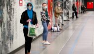 People stand on social distancing signs as they wait for a train at the San Giovanni subway station as the spread of the coronavirus disease (COVID-19) continues, in Rome, Italy, April 28, 2020. Reuters/Guglielmo Mangiapane
