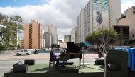 Pianist Rodrigo Cunha serenades from an open truck the lonely mothers in quarantine as the spread of the coronavirus disease (COVID-19) continues in Sao Paulo, Brazil, May 8, 2020. Picture taken May 8, 2020. REUTERS/Amanda Perobelli
