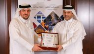 Sheikh Thani bin Ali Al Thani (right), Chairman of the Conference Organizing Committee, honouring Moutaz Al Khayyat, Chairman of UCC Holding, at a ceremony yesterday. 