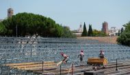 Workers build a seating area for socially distanced Rome Opera House's summer performances at Circus Maximus, the ancient chariot racetrack, following the coronavirus disease (COVID-19) outbreak in Rome, Italy, June 25, 2020. REUTERS/Guglielmo Mangiapane